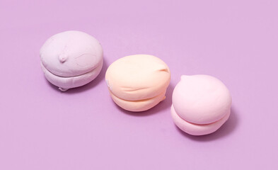 airy sweet vanilla marshmallow pastel color on pink purple background, top view