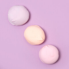 airy sweet vanilla marshmallow pastel color on pink purple background, flat lay
