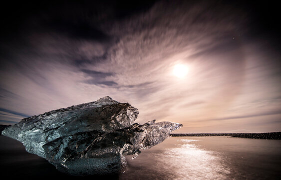 ceberg in iceland on the beach with full moon