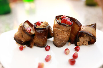 Eggplant rolls with nuts on plate