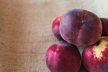 Closeup of peaches on raffia fabric