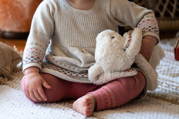 Child playing with a stuffed animal bunny toy