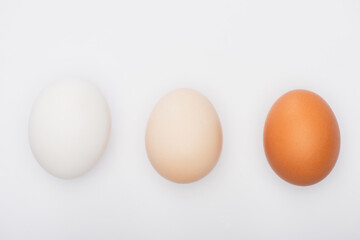 top view of colorful fresh chicken eggs isolated on white