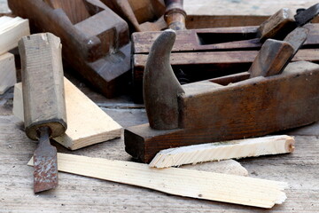 Old wooden carpenter's planes on a wooden background. Still life with old carpenter's planes
