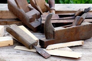 Old wooden carpenter's planes on a wooden background. Still life with old carpenter's planes