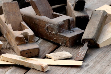 Old wooden carpenter's planes on a wooden background. Still life with old carpenter's planes