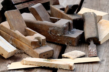 Old wooden carpenter's planes on a wooden background. Still life with old carpenter's planes