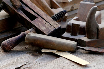 Old wooden carpenter's planes on a wooden background. Still life with old carpenter's planes