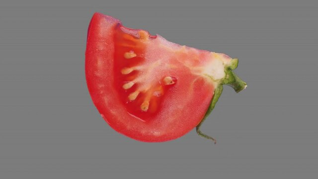 Fresh tomato slice spin and float - isolated on neutral gray. Seamless loop for unlimited duration. Alpha channel included for compositing projects. See usage examples in portfolio.