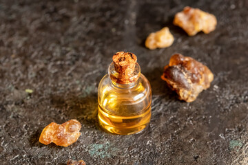 A bottle of frankincense essential oil with frankincense resin