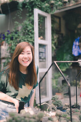 asian woman with smile and happy for plant care at her home