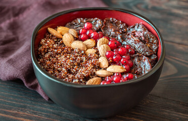 Bowl of red quinoa with nuts and sun-dried tomatoes