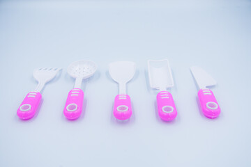 Children's pink plastic cooker for cooking on a white background