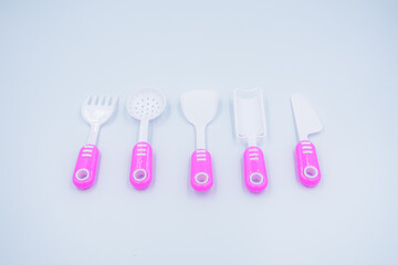 Children's pink plastic cooker for cooking on a white background