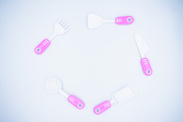 Children's pink plastic cooker for cooking on a white background