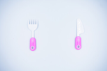 Children's pink plastic cooker for cooking on a white background