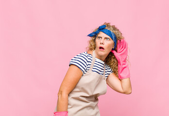 middle age womanlooking serious and curious, listening, trying to hear a secret conversation or...