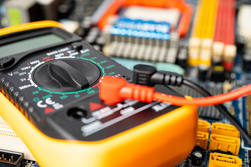 Multimeter with main board, maintenance, repairing and checking computer hardware concept.