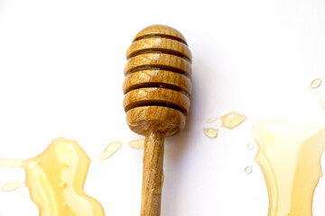 Wooden stick for honey drops of floral sweet honey top view