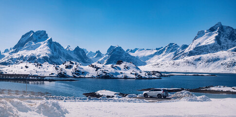 Fototapeta na wymiar Car parked by amazing mountain landscape in Lofoten Norway