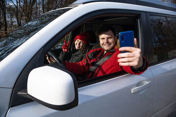 couple taking selfie picture in car