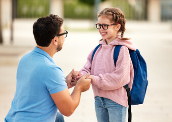 Father escorts his daughter  for school studies.