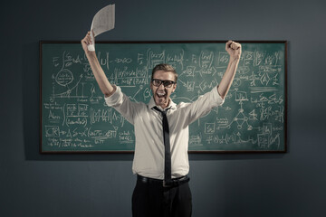 Cheerful successful mathematician solving a problem and celebrating