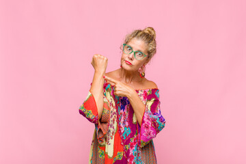 middle age woman looking impatient and angry, pointing at watch, asking for punctuality, wants to...