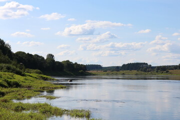 Sunny day on the river in summer in the village