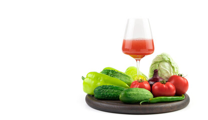 Fresh vegetables in a large assortment with a glass of freshly squeezed juice on a white background with a place to copy. Food background panorama. The concept of proper nutrition.