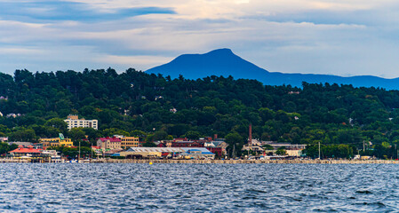 view of Burlington, Vermont waterfront from a sail boat on Lake Champlain with Camel's Hump...