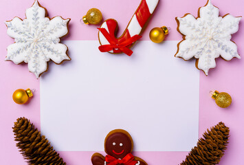 Mock up of holiday greeting card with gingerbread cookies on pink background