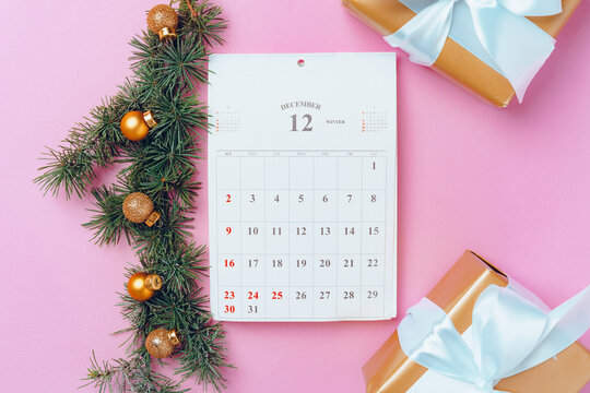 Calendar page of december with festive decorations on pink background - Powered by Adobe