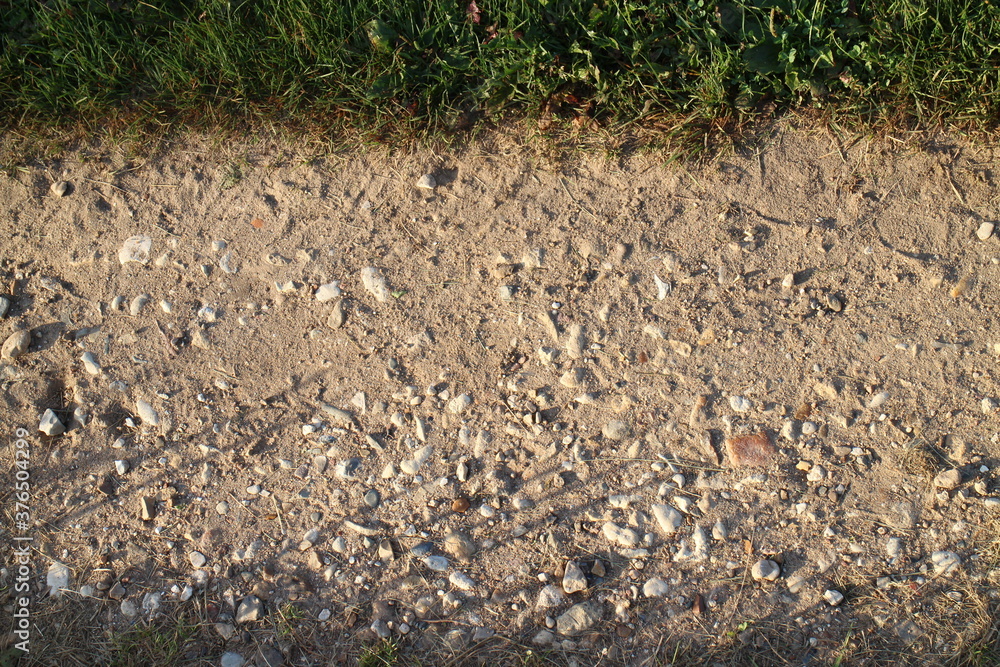 Wall mural stones on the village road in summer in the village