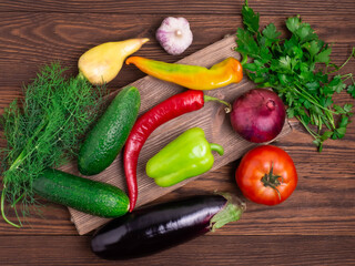 Tray with various vegetables on a dark wooden background