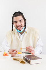 orthodox jew man celebrating rosh hashana, eating apple with honey