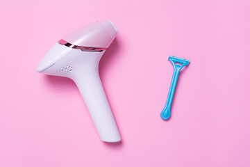Blue razor and photoepilatoron on a pink background. View from above. The concept of choosing a method of hair removal.