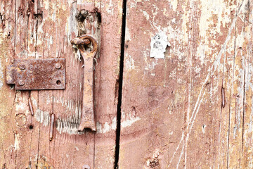 Old wooden background with remains of pieces of scraps of old paint on wood. Texture of an old tree, board with paint, vintage background peeling paint. old blue board with cracked pain