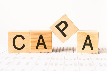 Word capa. Wooden small cubes with letters isolated on white background with copy space available