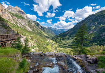 Fototapeta na wymiar Panorama of the Formazza Valley, where the Toce river forms a waterfall in La Frua (Northern Italy, Piedmont, on the border with Switzerland).