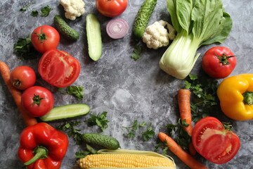 vegetables and fruits,vegetables, tomatoes, corn, cucumbers, pak choy, yellow pepper and carrots, fresh vegetables and vitamins arranged in a circle