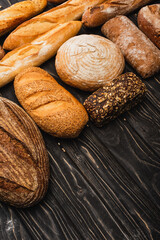 fresh baked bread loaves on wooden black surface