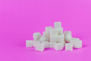 Sugar cubes on pink background