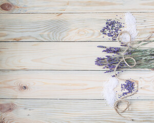 Obraz na płótnie Canvas Bunch of dried lavender and sea salt on wooden background. Top view, copyspace.