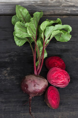 young fresh beets on a rustic wooden background in the cut