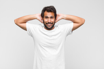 young latin handsome man feeling stressed, worried, anxious or scared, with hands on head, panicking at mistake