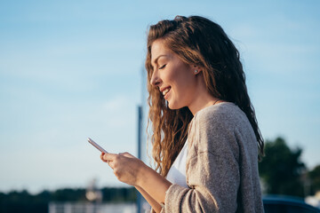 Young woman laughing at phone stock photo