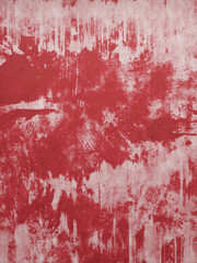 Worn off red paint on grungy wall background