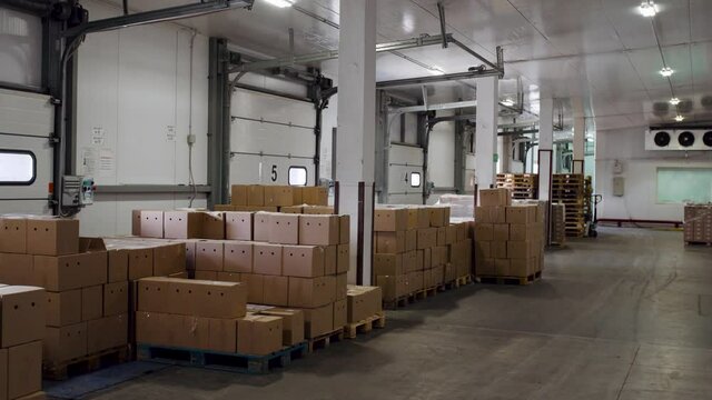 Warehouse with cardboard boxes inside, logistic center. large modern warehouse