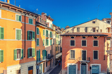 Fototapeta na wymiar Typical italian street with traditional colorful buildings with shutter windows, aerial view